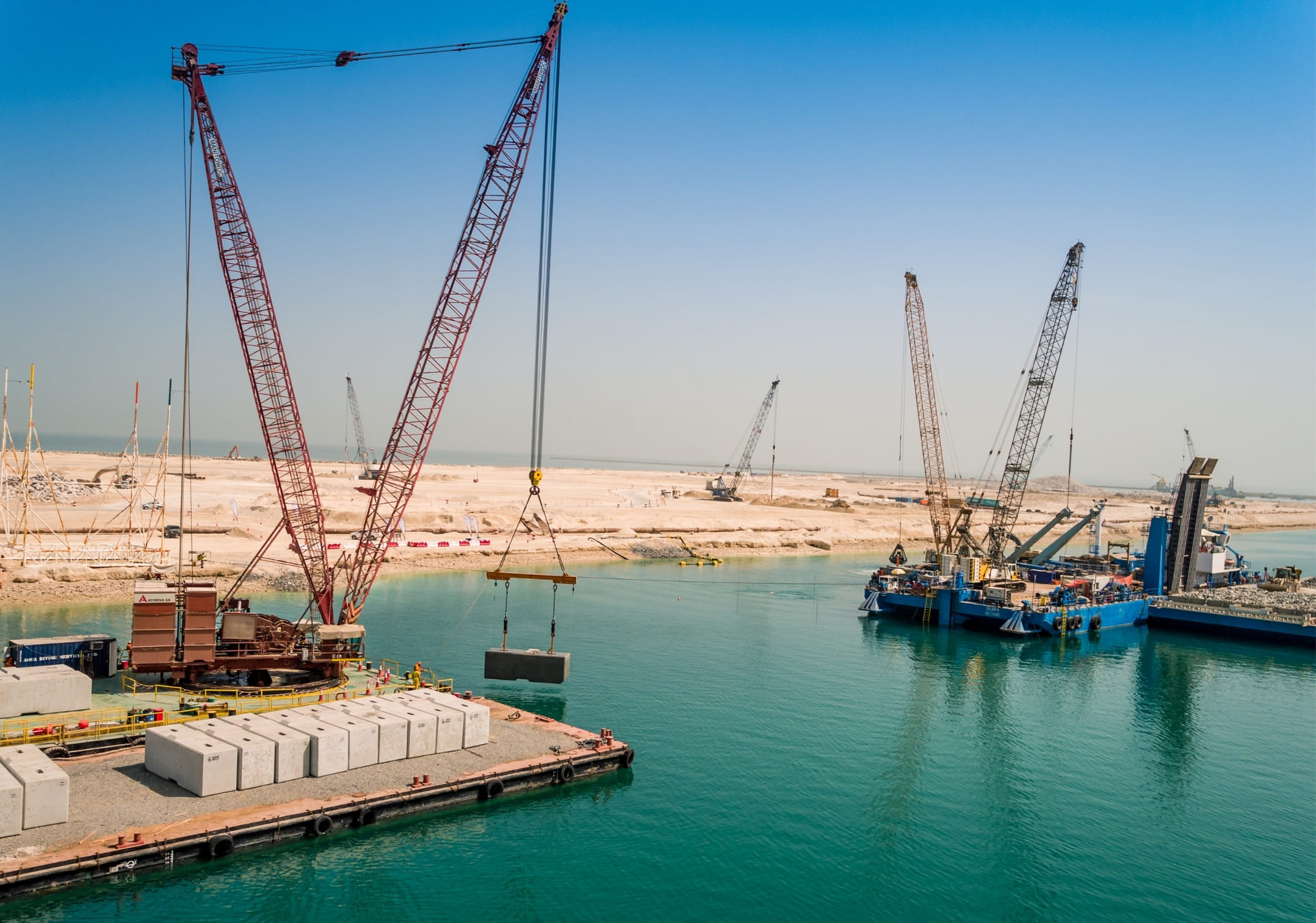 Quay wall block installation from marine cranes